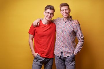Fototapeta premium Colorful studio portrait of two happy smiling friends.