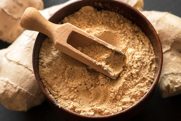 Ginger powder and ginger root. Food photo concept.