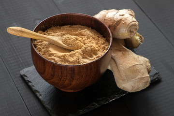 Ginger powder and ginger root. Food photo concept.