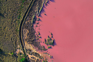 Aerial drone top-down photo of a beautiful natural pink lake located in Torrevieja, Spain. The lake turning into pink by a natural phenomenon and because it has high concentration of salt and algae