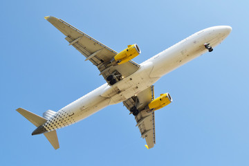 White and yellow plane undercarriage from below
