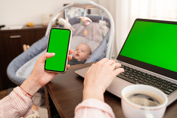 Woman hands browsing phone with blank screen for mock up template background, business technology and lifestyle background concept.  Using laptop and cell phone on home office. 