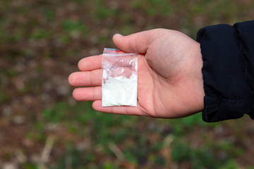 A bag of cocaine in the hands. Narcotic substances.