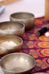 Tibetan singing bowls close up for a sound healing therapy session.