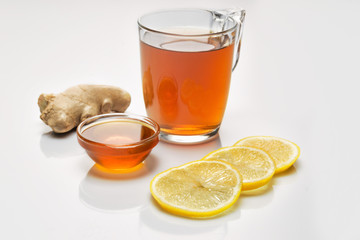 Ginger root, tea, honey, lemon on white background