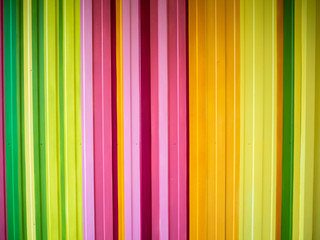 Obraz premium Bright multicolored metal wall painted in vertical stripes of different colors. Artistic and perfect for backgrounds, wallpapers, backdrops. Urban street art from modern artists.