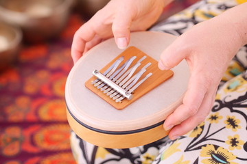 Close up of a sansula sound instrument played during a sound healing therapy healing session. 