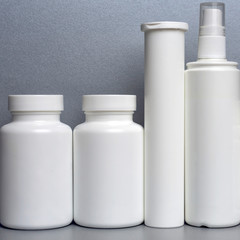 photo of four plastic cans for package pills and vitamins and antiseptic spray for protection...