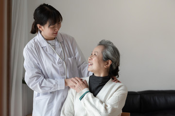 Young family doctor is talking with seniors
