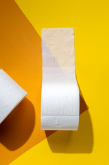 white toilet paper rolls on colored backgrounds