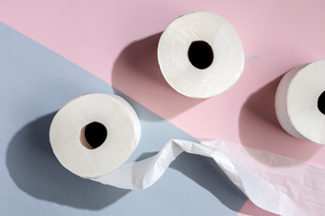 white toilet paper rolls on colored backgrounds