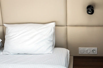 large bed with pillows in the hotel or at home. Concept on preparation of the bed in a hotel room or at home