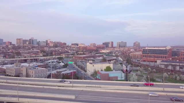 Aerial shot rising up from behind a highway to reveal Wilmington Delaware