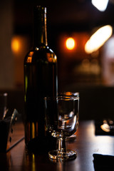 bottle and glasses on the bar