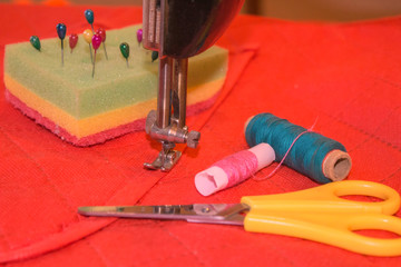 Sewing still life: colorful cloth. Sewing kit includes threads of different colors, thimble and other sewing accessories