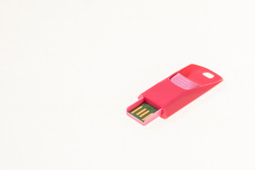 Pink USB flash memory isolated on white background.