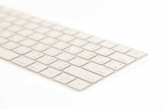 Close up of a white keyboard on white background. Image with soft focus.