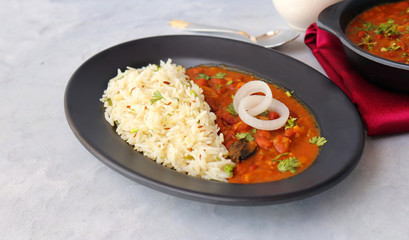 Rajma Chawal is a popular North Indian Food. Rajma is a socked Red kidney beans cooked with onions, tomatoes and a special blend of spices. Served with Jeera rice or Cumin Rice. With Copy Space.