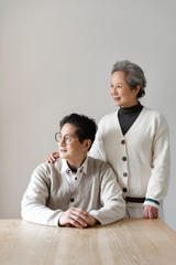 An Asian elderly couple sitting at the table