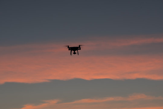 Flying drone above the professional camera takes pictures of the Sky