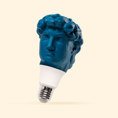 White lightbulb made of blue statue head on pink background. Negative space to insert your text....