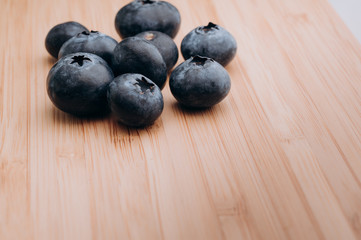 juicy fresh blueberries lay on the wooden table