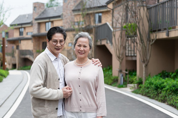 An Asian elderly couple walking in the community