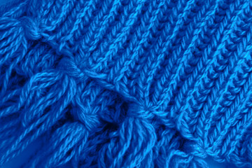 A fragment of a woolen scarf. The concept of care and warmth. Close-up.