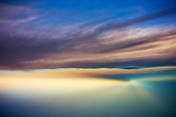 sunset view from the plane between clouds