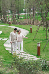 Fototapeta premium An Asian elderly couple walking in the community