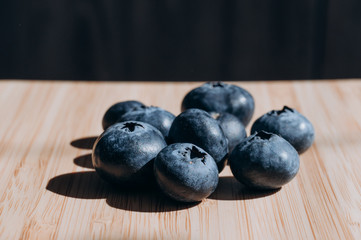 juicy fresh blueberries lay on the wooden table