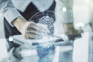 Double exposure of abstract creative fingerprint hologram with man hand writing in notebook on background, research and development concept