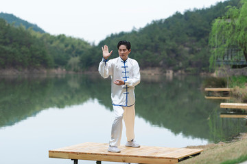 An Asian elderly man doing sports by the lake