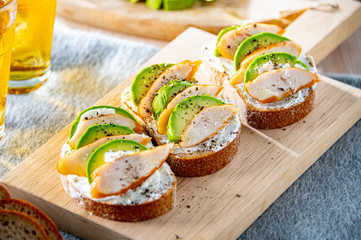 Delicious sandwich with avocado,cheese and chicken breast strips.