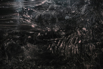 photo of a feather on a dark blurred background on glass