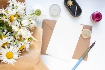card mockup with daisies and envelope. wedding invitation in minimalist style with leaves