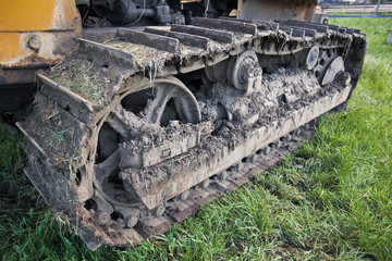 Fototapeta na wymiar crawler tractor covered with earth