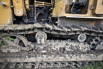 crawler tractor covered with earth