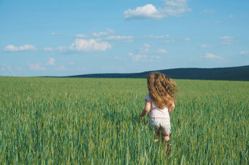 girl running in green grass