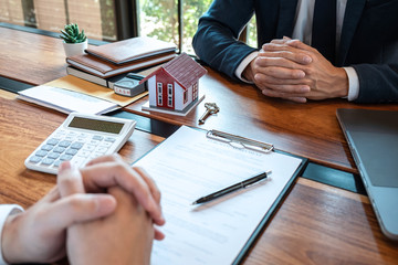 Real estate agent are presenting home loan and sending keys to customer after signing contract to buy house with approved property application form, Insurance Home concept