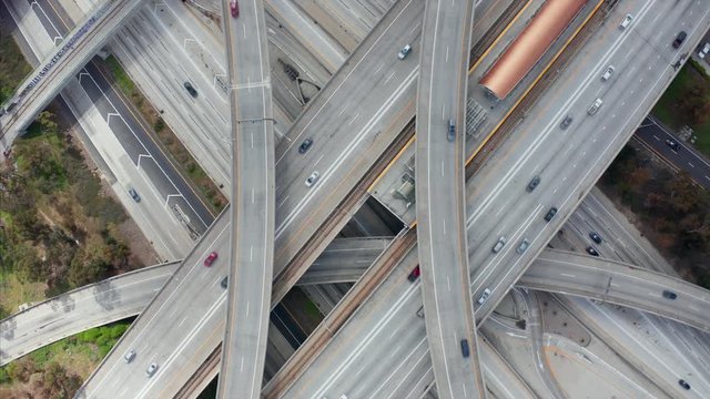 AERIAL: Spectacular Overhead Shot of Judge Pregerson Highway showing multiple Roads, Bridges, Viaducts with little car traffic in Los Angeles, California on Beautiful Sunny Day