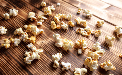 Fototapeta na wymiar Popcorn flakes on a wooden background