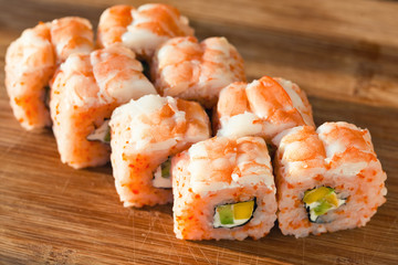 Suchi rolls with shrimp and avocado on a board