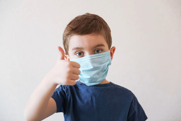 Coronavirus and Air pollution concept. Little boy wearing mask for protect and show thumbs up gesture for good air at home.