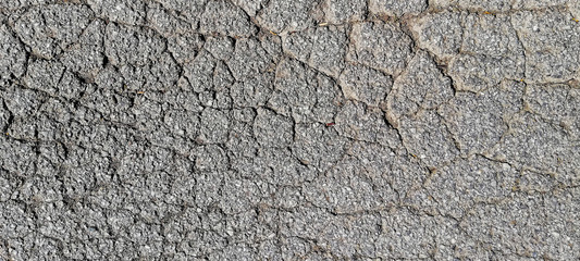 texture of old cracked asphalt surface background
