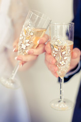 two decorated glasses of champagne on the wedding