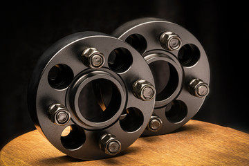 two black wheel spacers to reduce wheel departure