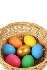 Colorful Easter eggs in the basket on the white background