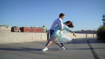 couple dancing on the shore. Young couple dancing on the promenade © Ruslan