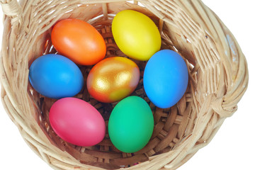 Obraz na płótnie Canvas Colorful Easter eggs in the basket on the white background